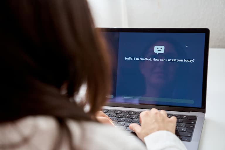 Person using AI chatbot on laptop