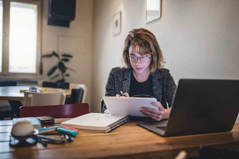 Online college student taking notes